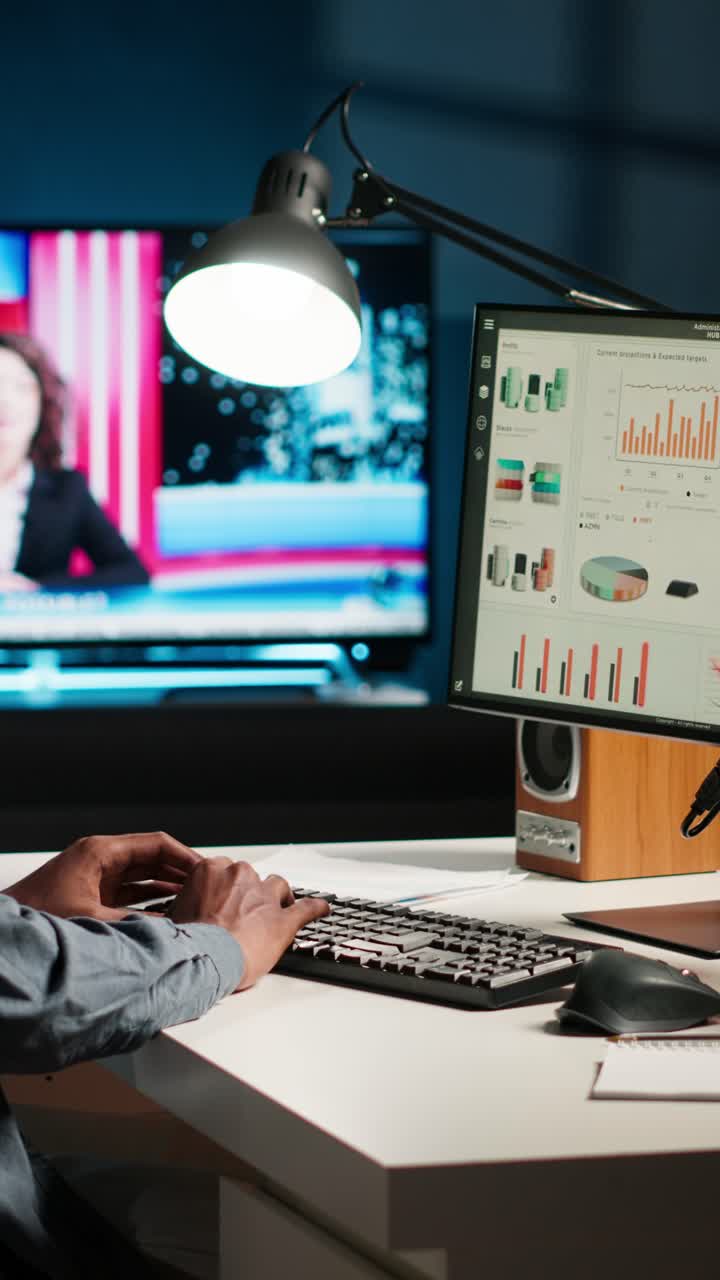 Working on Computer with News Report | Premium Stock Video Footage