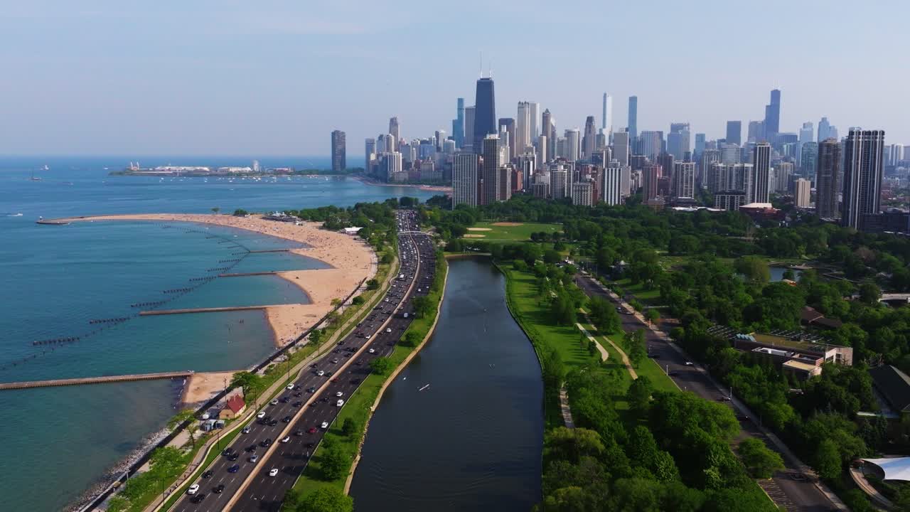 Drone Descends to Reveal Lincoln Park South Lagoon. Chicago Skyscrapers. Summer