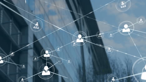 animation of network of profile icons against low angle view of tall building and blue sky