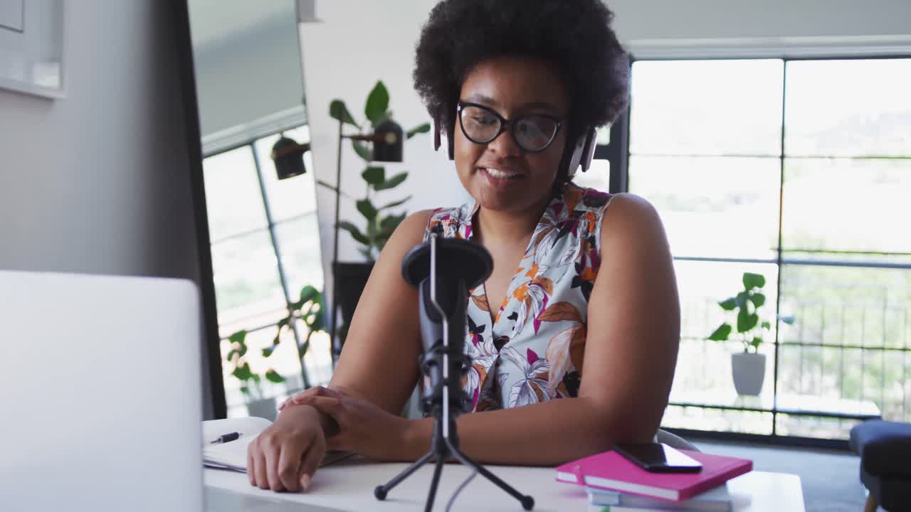 African american female plus size vlogger sitting using computer having a video chat