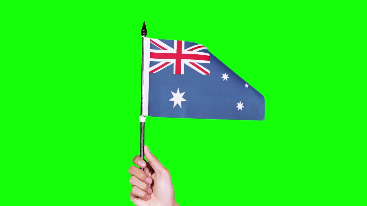 Hand holding an Australian flag in studio