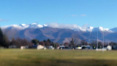 Snow-capped-mountain-range-behind-fogged-window