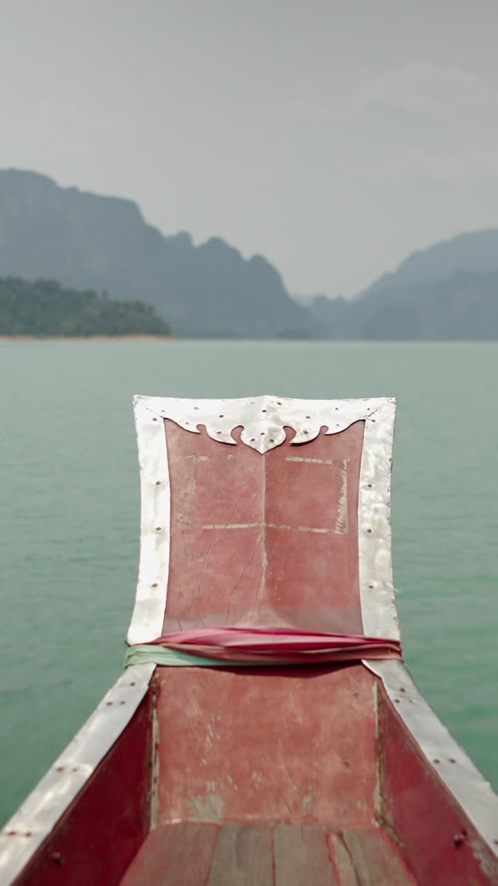 Boat on a serene lake surrounded by mountains