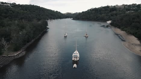 3 yachts anchor peacefully in middle harbour, sydney