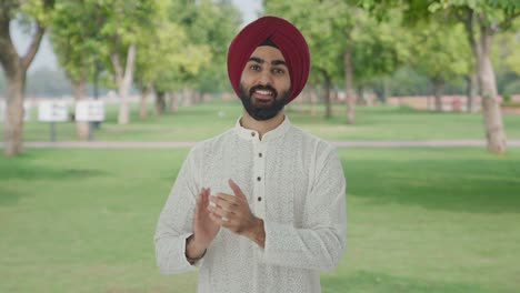 Happy-Sikh-Indian-man-clapping-and-appreciating-in-park