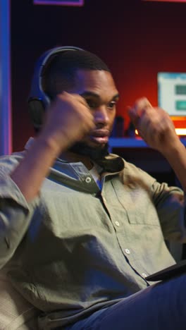 vertical video black person listening to focus music on headphones to finish tasks