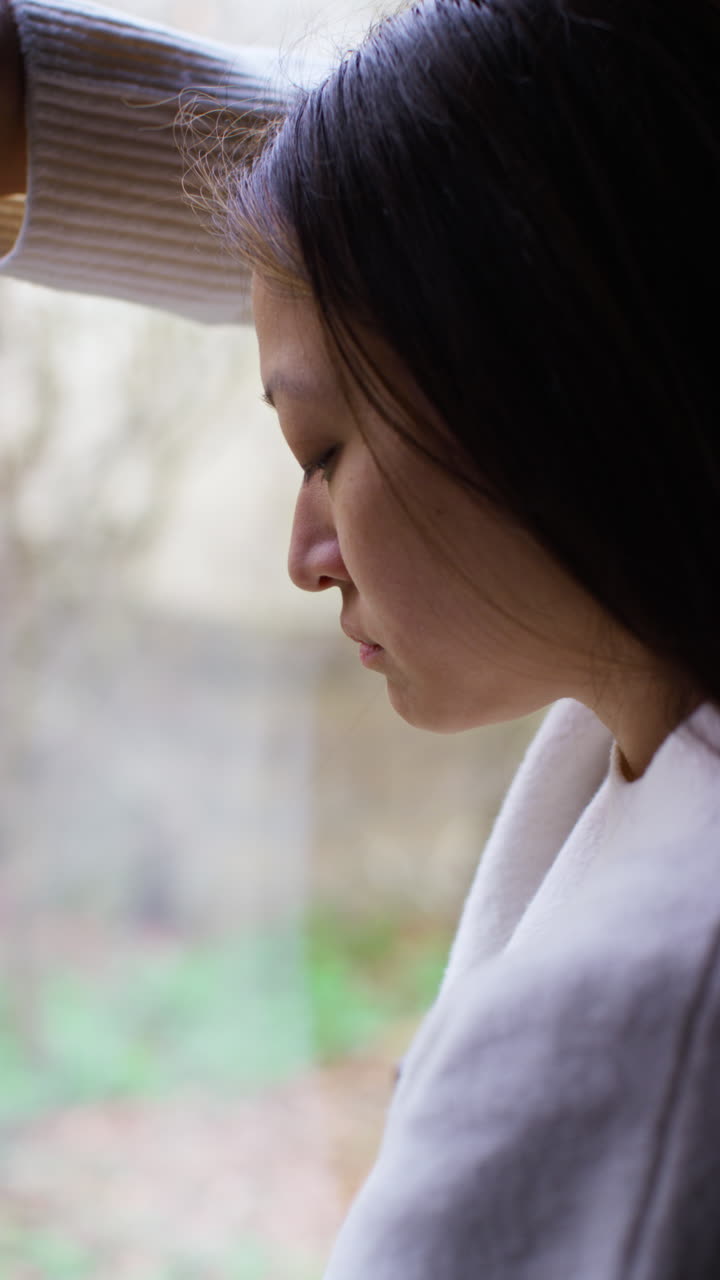 Vertical Video Close Up Of Stressed Or Anxious Woman Suffering With Depression Anxiety Loneliness Or Agoraphobia Leaning Against Window At Home 2