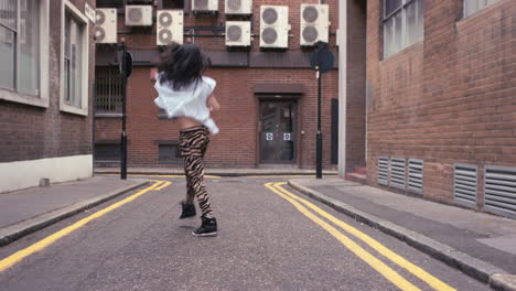 contemporary funky asian woman street dancer dancing freestyle in the city