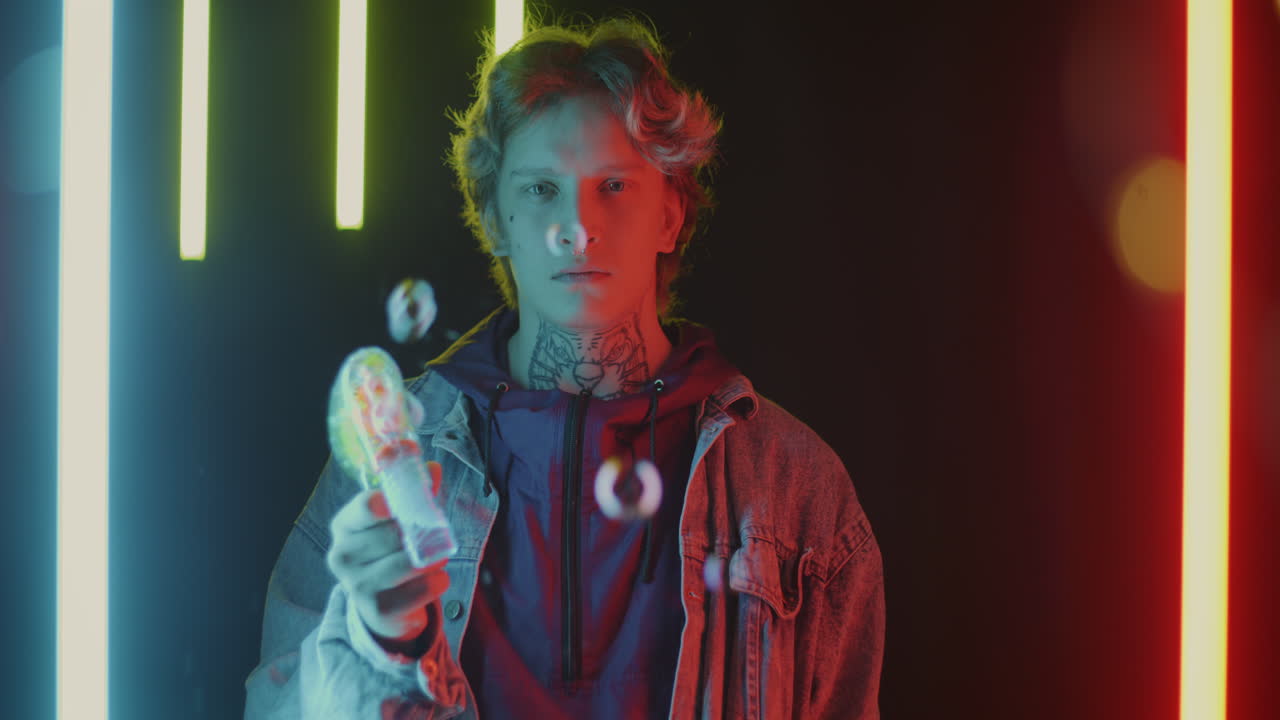 Neon Portrait of a Young Man with Tattoos Blowing Bubbles