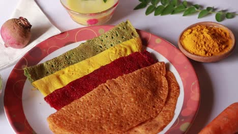 dosa in different colors on white background