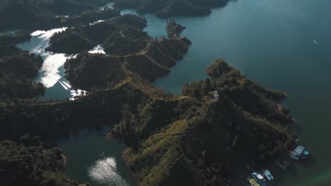 drone aerial view of the lake and green islands during daytime at el peñón in guatapé, colombia