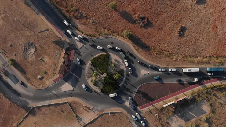 Top down drone view of a busy roundabout in Portugal,orange and green earthy tones