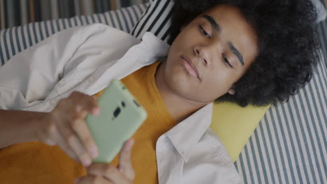 Teenager Using Smartphone on a Couch