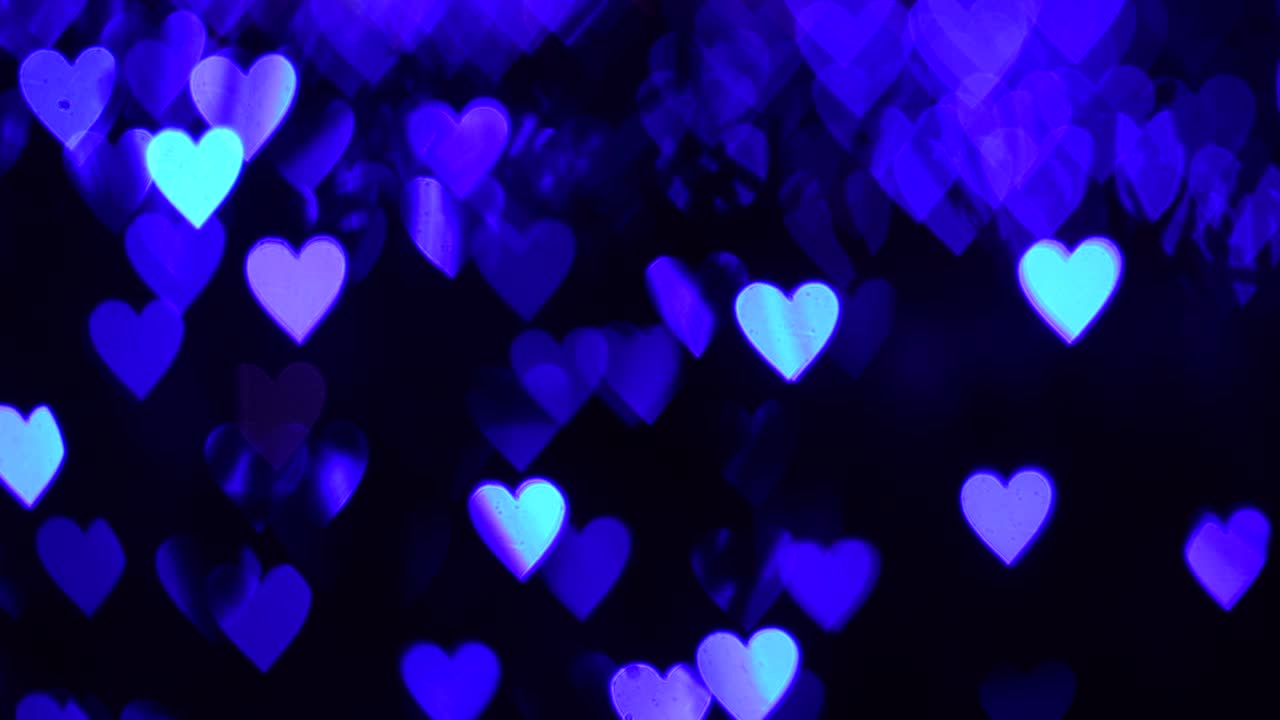 4k uhd video de fondo para el día de san valentín. frontera con bokeh de corazones azules brillantes románticos en un fondo oscuro. amor, bokeh en forma de corazón