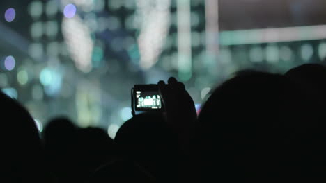 people on the concert taking photos of the stage