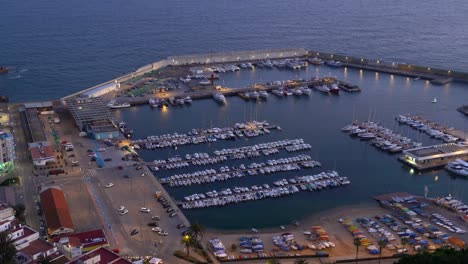 Blanes-city-on-the-Costa-Brava-of-Spain,-tourist-beach-town-sunset-and-night-images-marina-and-fishing-port-moored-boats-catalunya