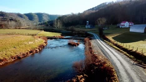 aerial-pullout-from-farm-along-country-road-near-boone-and-blowing-rock-nc,-north-carolina-along-the-watauga-river