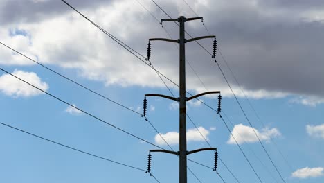 a windy day time lapse of a high voltage power line and clouds forming and passing behind it as is shakes and shimmies in the wind
