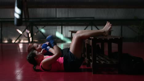 two women doing an abs workout in a gym