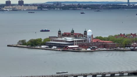 Aerial-view-of-Ellis-Island-with-tourism-boats-on-water-in-NYC