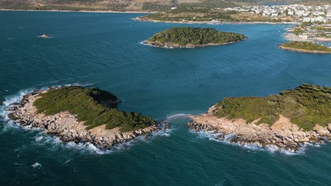 Aerial-drone-trucking-shot-of-Isole-Gemelle-in-the-Albanian-Riviera-on-a-sunny-day