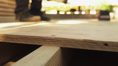 Carpenter-measuring-plywood-before-cutting,-closeup