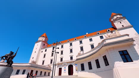 front façade of the beautiful bratislava castle, slovakia. low angle view. a monument on the horse opposite the entrance