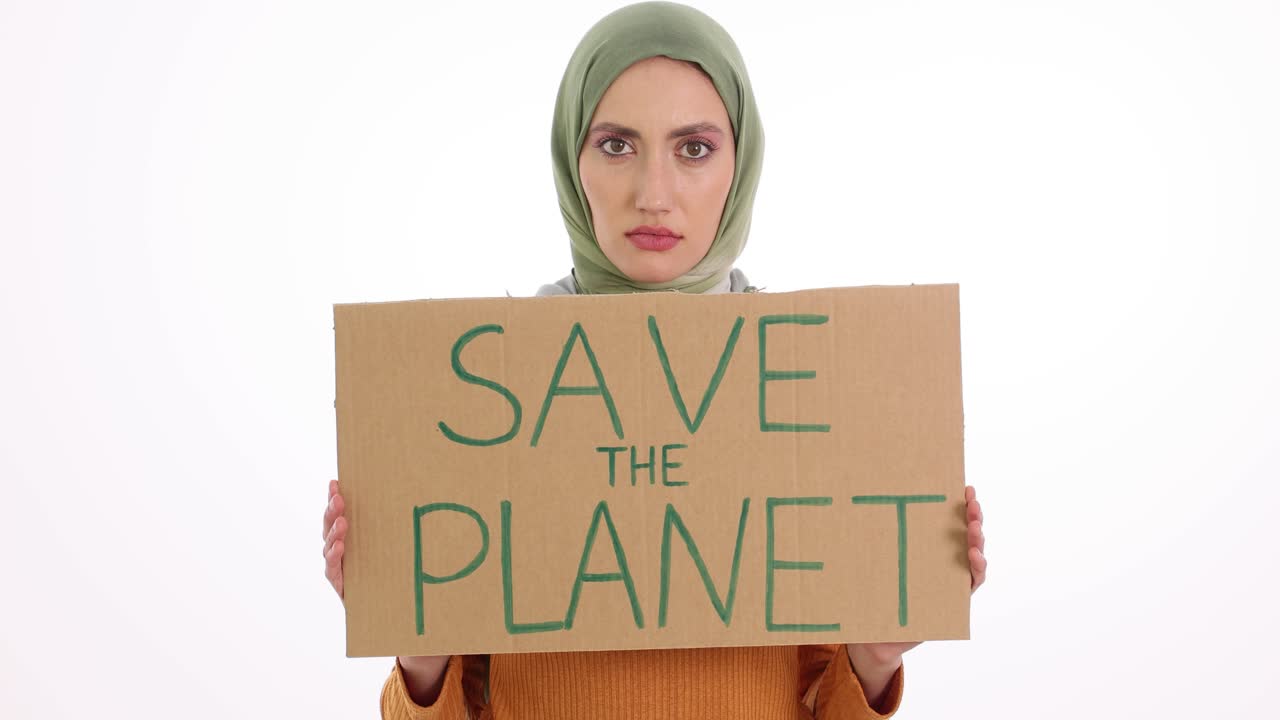 Young Woman in Hijab Holds "Save The Planet" Sign Against White Background