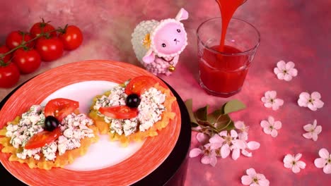 vegetarian sandwich with cottage cheese, dill, tomatoes and olives, rotate slowly. pouring tomato juice in drinking glass. pink light.