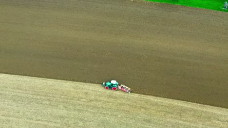 drone fly over field plowing tractor 4k