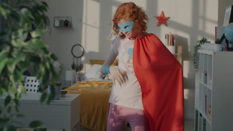 young superhero having fun in her bedroom
