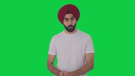 serious sikh indian man talking green screen