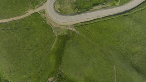 Countryside-road,-pathway-and-a-vibrant-grassfield-in-the-Kojori-area,-Georgia