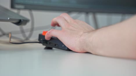 hands operating a colorful computer keyboard comes into focus as a user starts typing on a keyboard