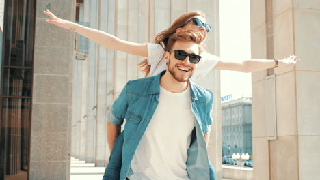 couple having fun piggyback ride in city