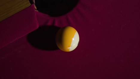 slow motion cue ball hits striped ball into hole on the pool table