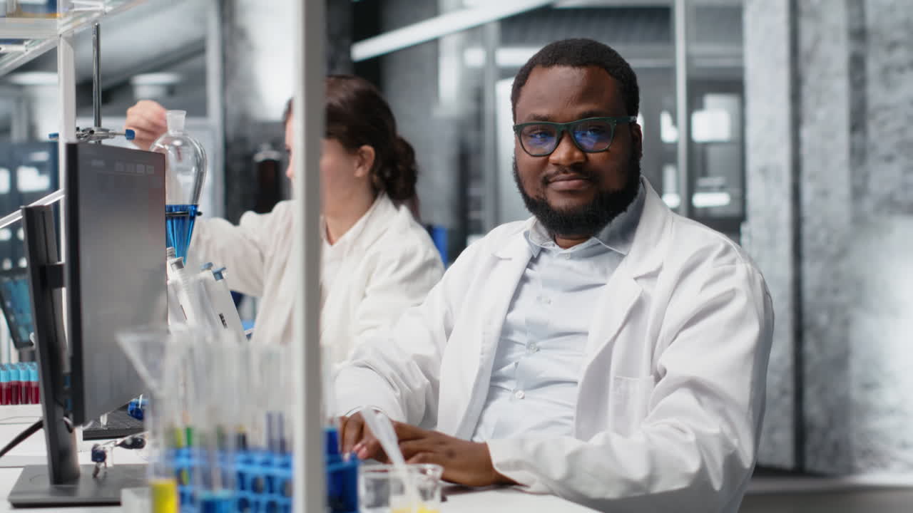 Vertical video Jolly laboratory researcher using computer monitor