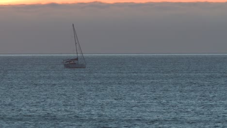 Tropical-sunset-with-fishing-ship-in-middle-of-Atlantic-sea