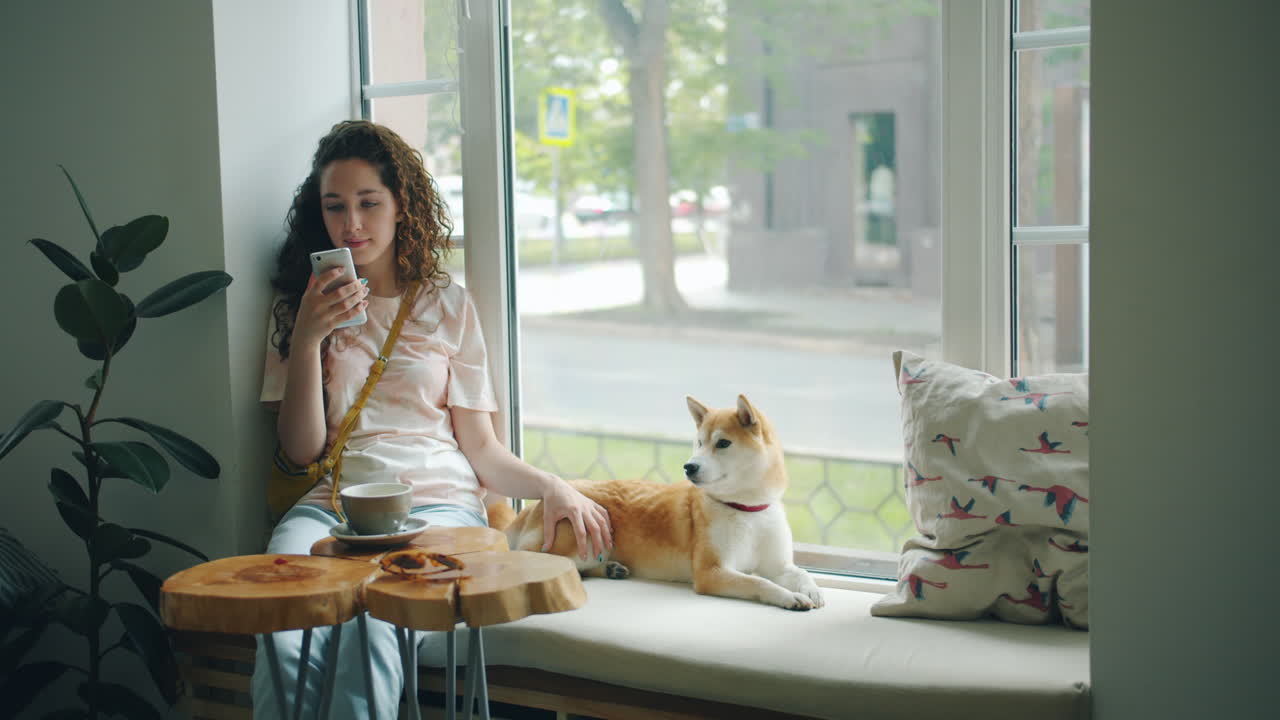 Young Woman with Dog in a Cafe