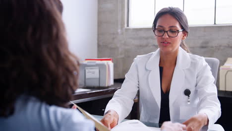 young female doctor advising a young female patient