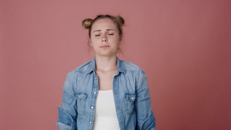 Serious-female-caucasian-teenager-screaming-on-pink-background.