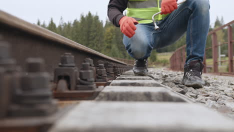 railroad worker performing maintenance on railway tracks