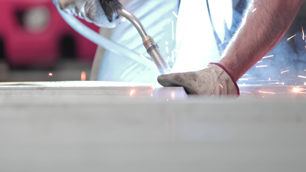 Welder Welding Metal Frame In A Factory - close up, slow motion