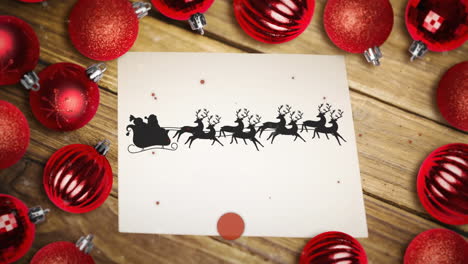 partículas rojas sobre santa claus en trineo siendo tirado por renos en un papel y múltiples bolas