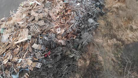 Aerial-Shot-Of-Abandoned-Wood-Pallets-At-A-Garbage-Landfill-Dump,-Landfill-Recovery-Collection