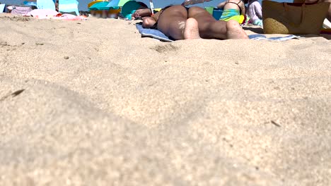 close-up view of a woman lying in the sun, relaxing and enjoying her summer vacation in europe