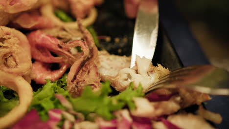 fork and knife grabbing shirmps during gourmet dinner