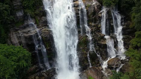 slow rotating aerial detail view of waterfall in tropical jungle