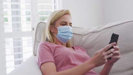 Woman-wearing-face-mask-using-smartphone