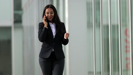 Smiling-Asian-woman-talking-on-smartphone-outdoor